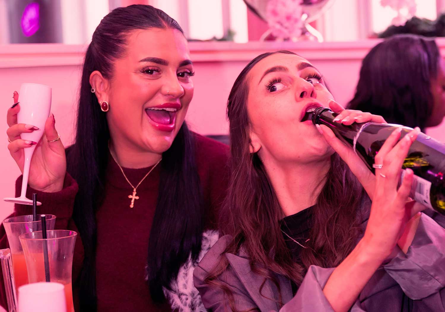 Girls having fun drinking prosecco from the bottle at Lovebrunch Greenwich close up