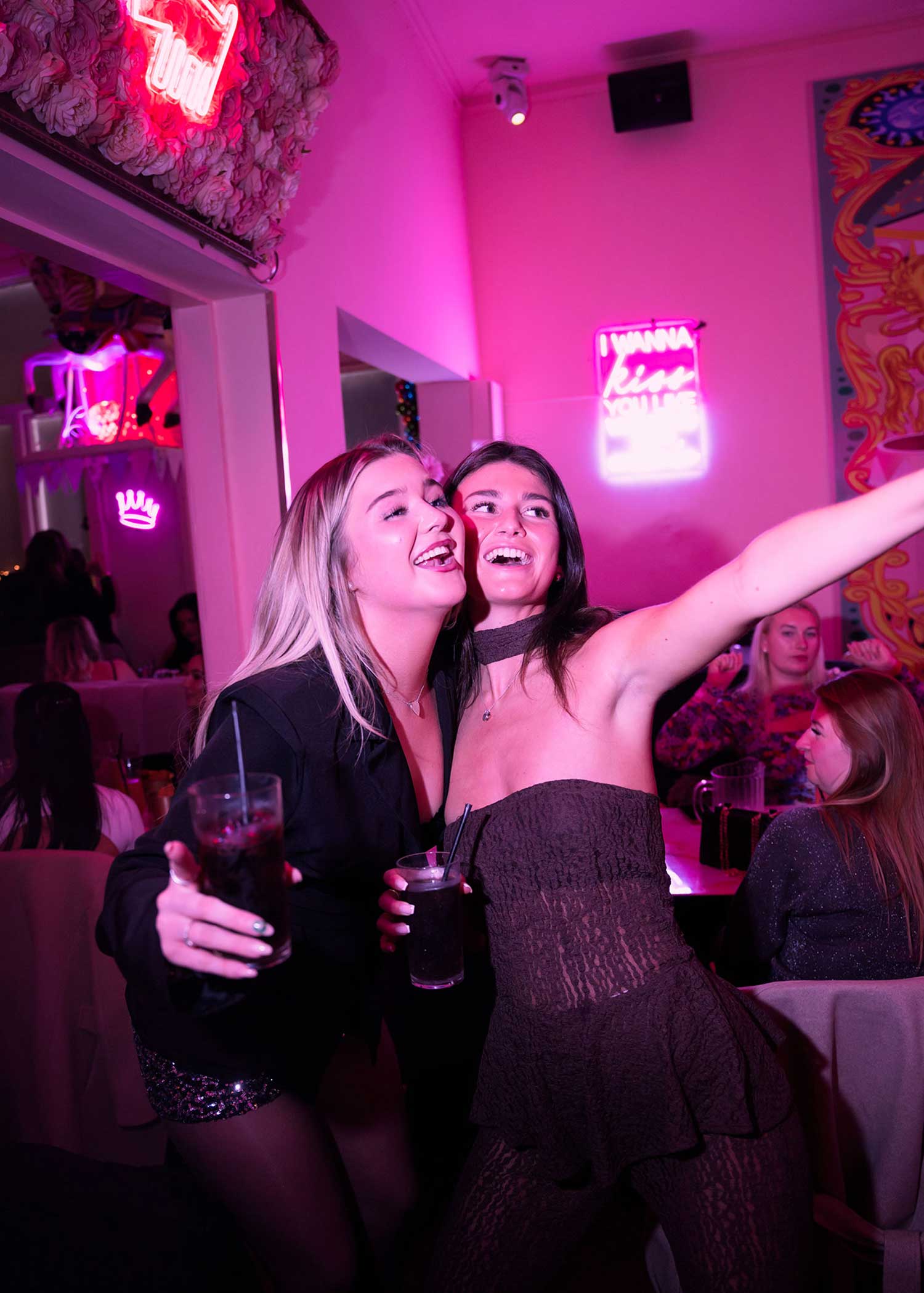 Saturday night clubbing vibes with girls having fun in pink restaurant
